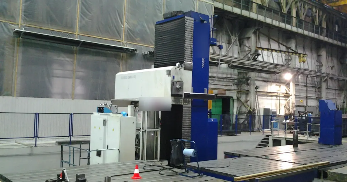 Floor type horizontal boring mill with its column and spindle head beside a steel floor plate, the kind of machine used for a horizontal boring mill weldment